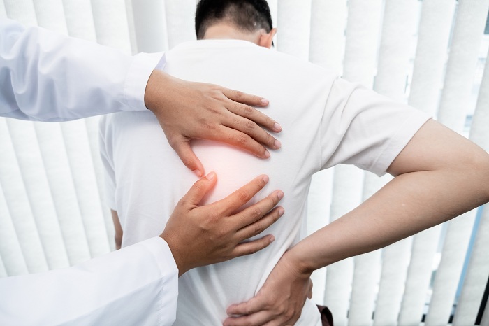Male patient consulting a physiotherapist for back pain problems
