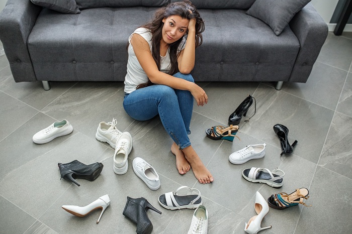 Woman with a lot of shoes to select from