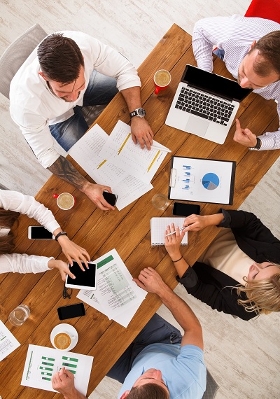 Busy business group over a meeting on a wooden desk